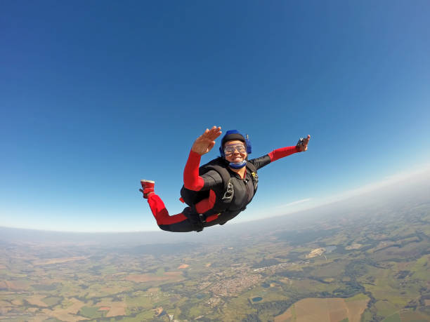 istock Smiling black woman jumping from parachute 954842156