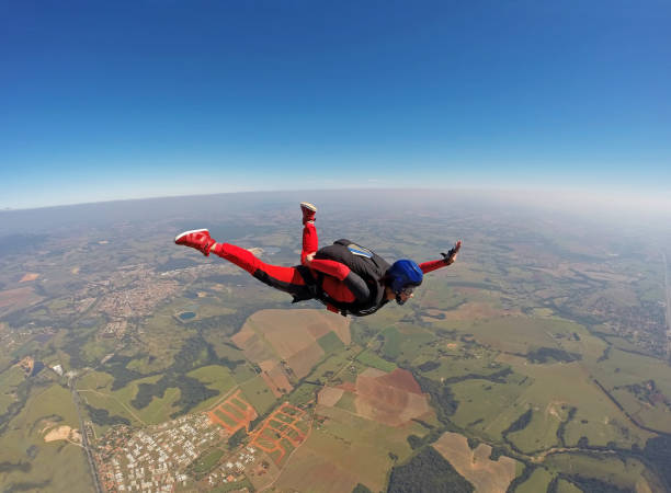 istock Smiling black woman jumping from parachute 954842174