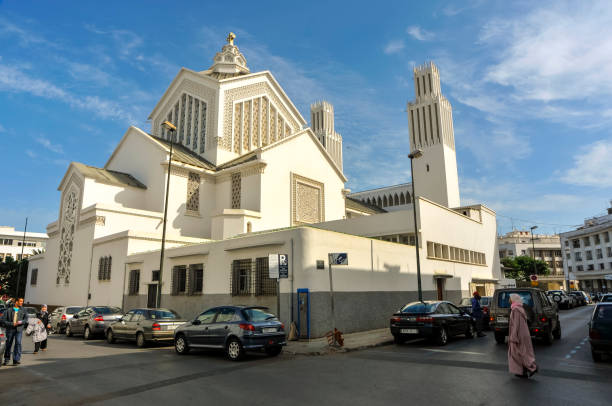 Fez, Morocco - September, 25 2017: Cars, motor scooters, people and  background St. Peter's Cathedral in the streets of Rabat in Morocco. Rabat is the capital city of Morocco and its second largest city.