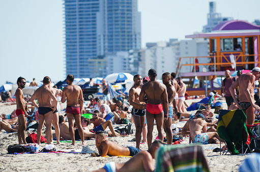 Miami - April 28, 2018: Sunbathers gather on a sunny weekend afternoon on South Beach as summer weather sets in.