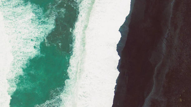 istock Ocean foam and black sand beach 954847728
