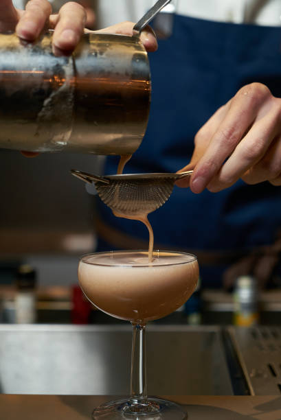 istock Professional bartender making a cocktail at the bar counter 954850682