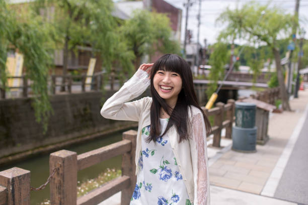 istock Happy young woman walking along river 954851374