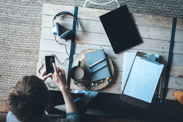 istock woman using phone in the room 954851524