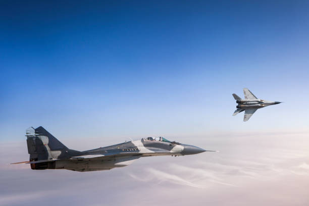 istock Mig-29 Fighter Jets in Flight over the clouds 954854642