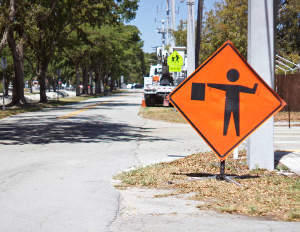 istock flagman sign with heavy equipment blurred in distance 954873206