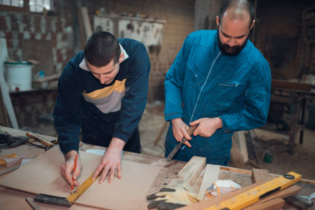 istock Young carpenters working in the workshop 954881760
