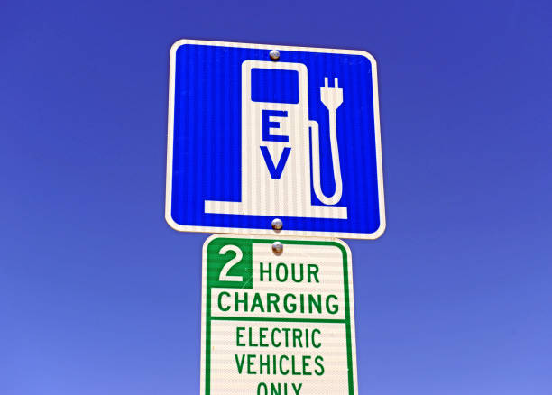 istock Electric Vehicle charging sign, a power source eventually expected to replace fossil fuels such as gasoline and oil in operating a car and other motor vehicles 954882000