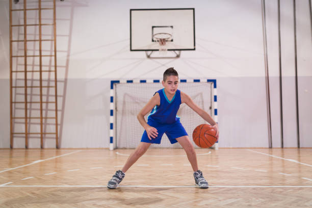 istock Young basketball player having a training class indoors 954884876
