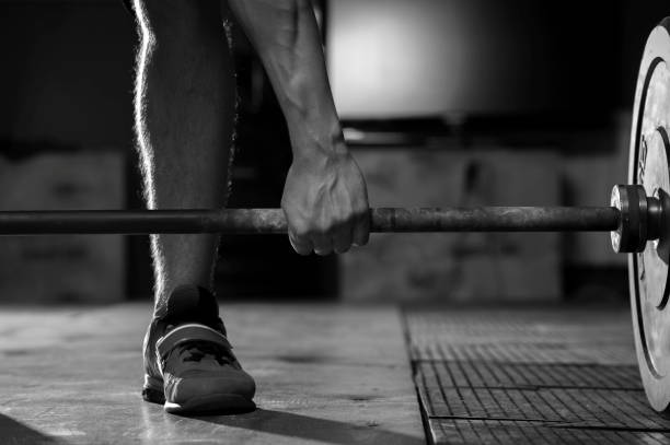 istock Male hand holding barbell before training 954895792