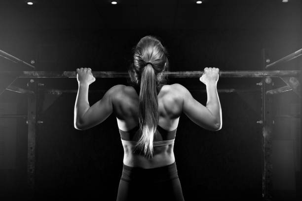 istock Young fitness female doing pull ups exercise 954896138
