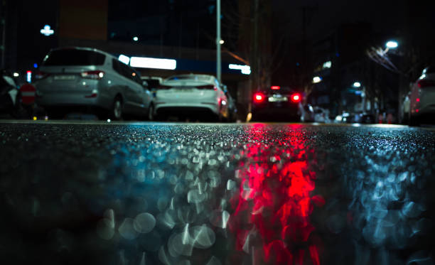 Cars red stop lights reflection on wet asphalt
