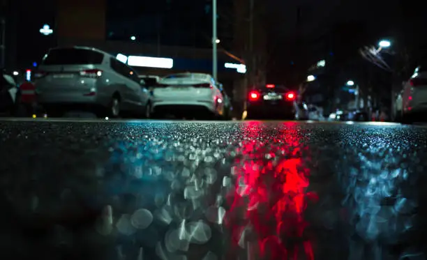 Photo of Cars red stop lights reflection on wet asphalt