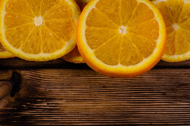 istock Orange slices on wooden table. Top view 954902110