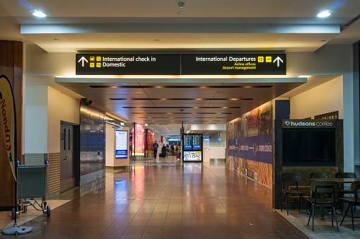 Melbourne, Australia - December 10, 2016: Hall and walkway in Melbourne airport with navigation boards to domestic airport, international check-in zone and departure