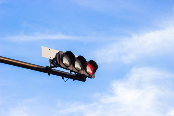 istock Red traffic light signals in japan with bright blue sky background. 954906864