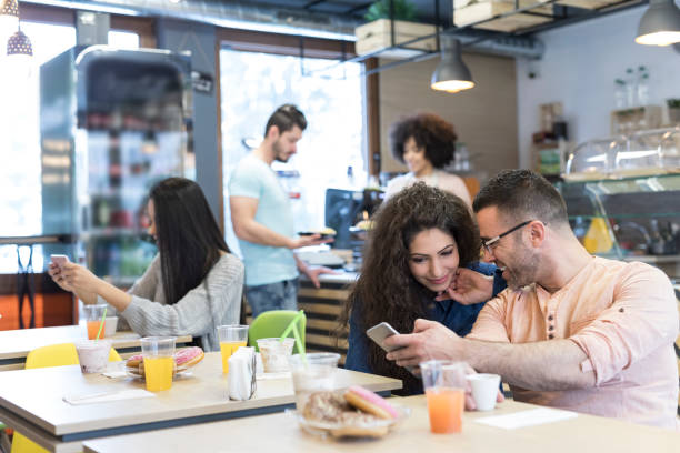 istock Couple taking selfie in cafeteria 954910280