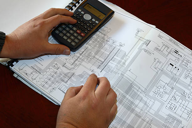 Engineer calculating on diagram stock photo