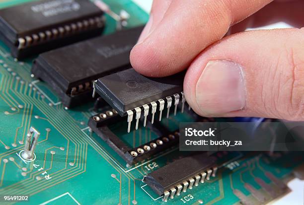 Inserting A Microchip Stock Photo - Download Image Now - Circuit Board, Printing Out, CPU