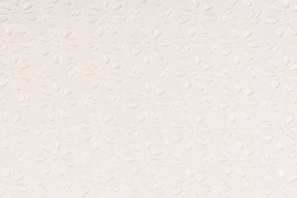 istock Beige self made paper pressed flowers sheet texture background. Embossed lace pattern. 954912734