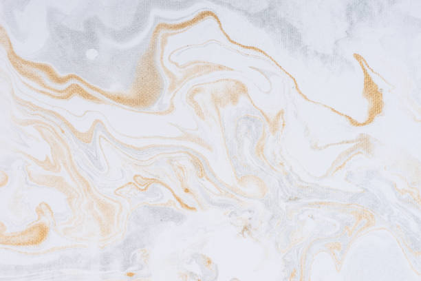 istock White paper sheet texture background. Flowing colors. Golden and silver fluid color pattern. 954912816
