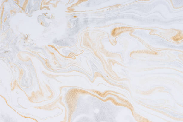 istock White paper sheet texture background. Flowing colors. Golden and silver fluid color pattern. 954912892