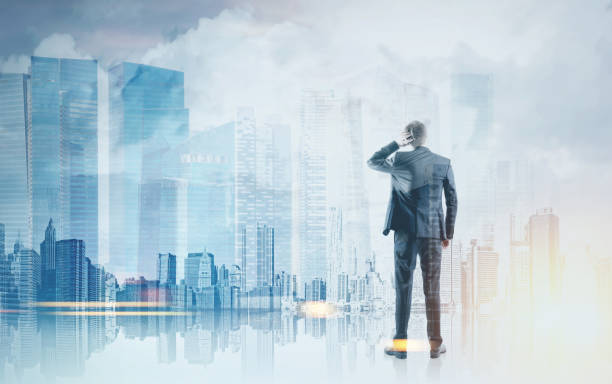 istock Rear view businessman scratching head, blue city 954918406