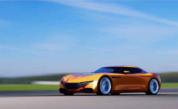 istock orange car driving on a road 954918432