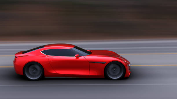 istock red car driving on a road 954922298
