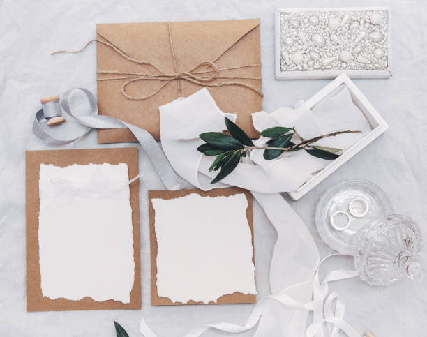istock Wedding desktop mockup with green olive branch and white empty card with envelope on linen background. Rustic wedding. Top view. Flat lay 954922504