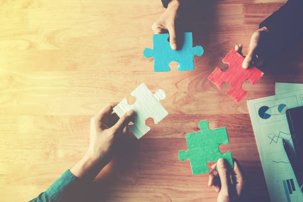 istock Teamwork meeting Business Jigsaw Puzzle solution together concept 954922962
