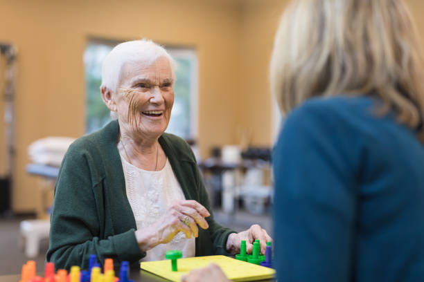 istock Occupational therapist works with an elderly woman 954923220