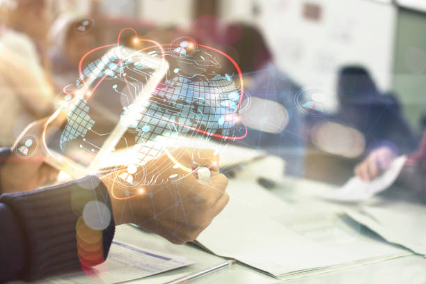 istock Businessman holding in hand tablet with global connection concept 954923598