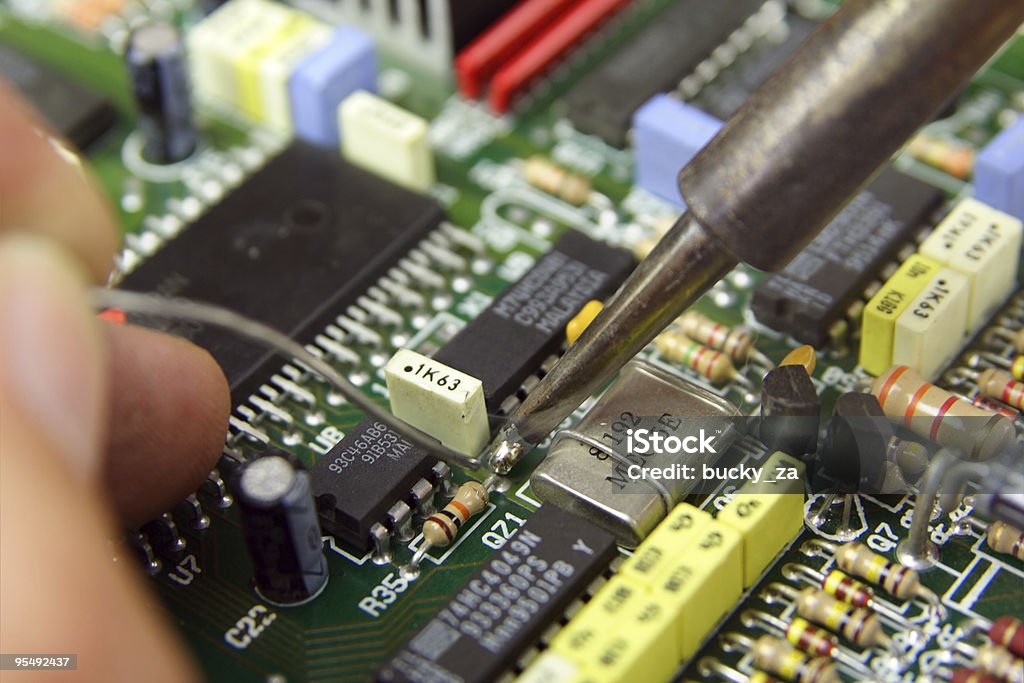 Macro shot of a technician soldering electronic components  Capacitor Stock Photo