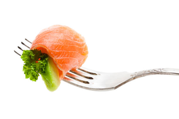 istock Salmon  piece with avocado on fork isolated on white 954924430