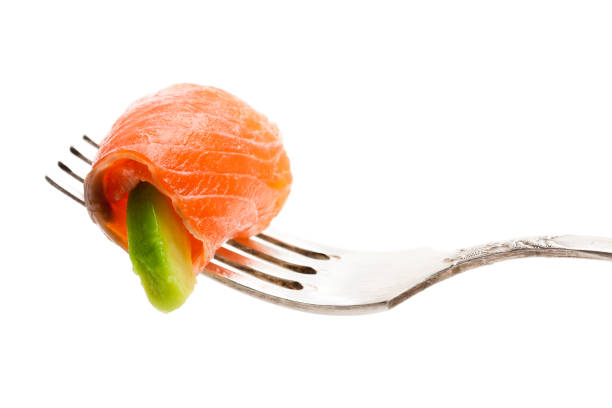 istock Salmon  piece with avocado on fork isolated on white 954927434