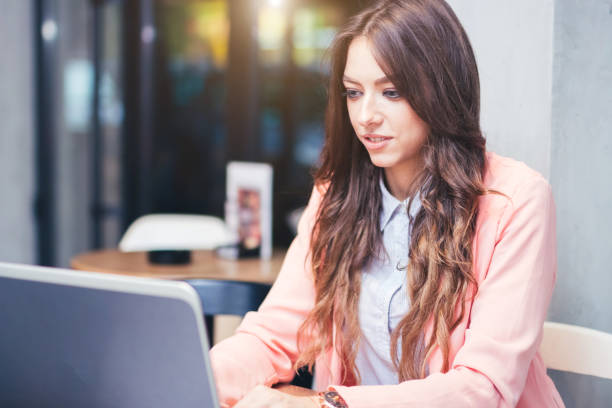 istock Modern and Business Girl uses a laptop computer at a cafe. 954928470
