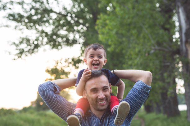 istock Father carry his son on the shoulders 954929016