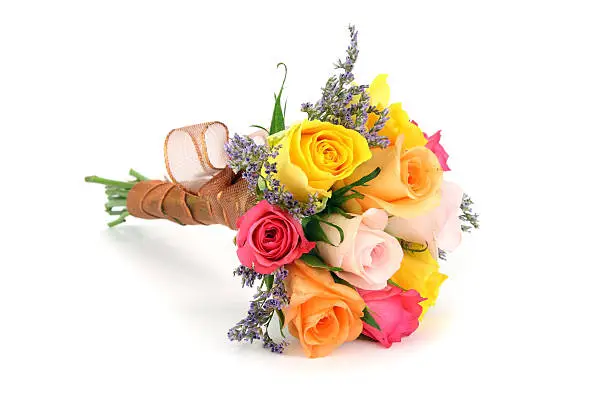 Photo of Colorful bouquet or posy with stems wrapped in ribbon.