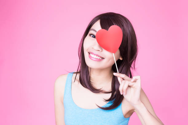 istock woman holding red love heart 954932422