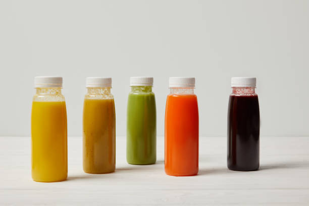 istock colorful detox smoothies in bottles on white wooden surface 954933154