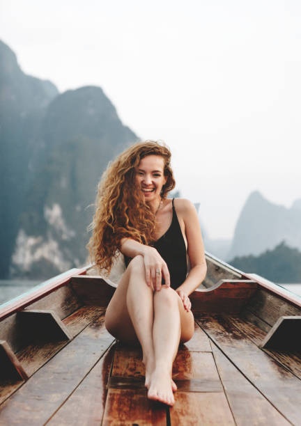 istock Beautiful woman posing on a boat 954936570