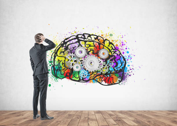 istock Confused businessman, rear view, cog brain 954936686