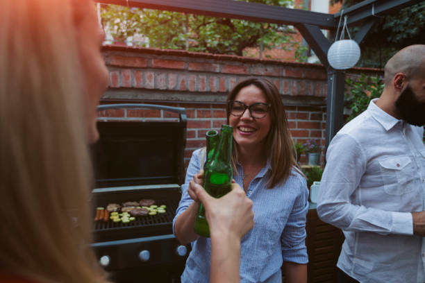 istock Friends Watching Sports On Big Screen In Backyard 954937112