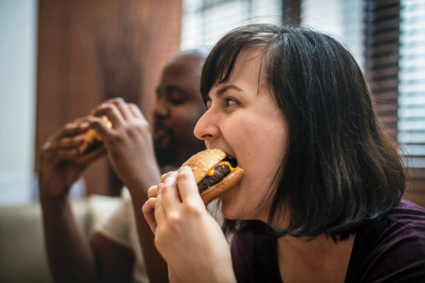 istock Couple having fast food on the couch 954937236