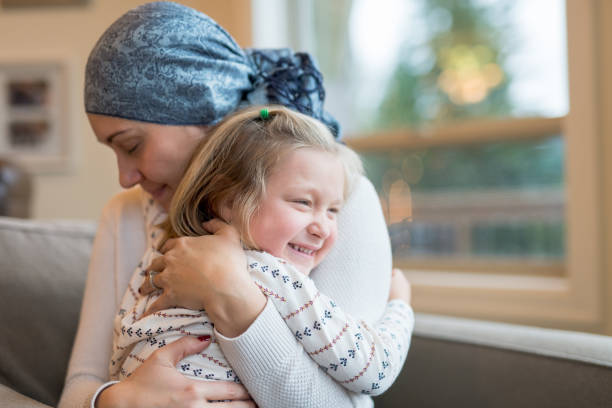 istock Young mom with cancer holds her daughter tightly 954939862
