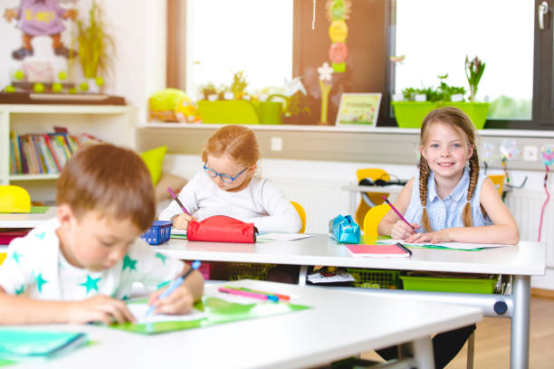 istock cool and Beautiful young kids have fun in school while learning in classroom 954945006