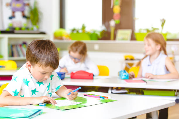istock cool and Beautiful young kids have fun in school while learning in classroom 954945024