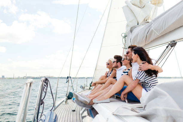 istock smiling friends sitting on yacht deck 954946278