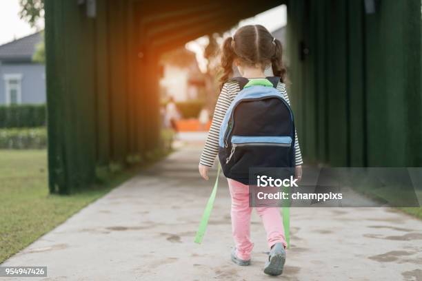 Kid Girl Pupil Walking Back To Home After Learning Study School Alone With Schoolbagpreschool And Kindergarten Education Concept Stock Photo - Download Image Now